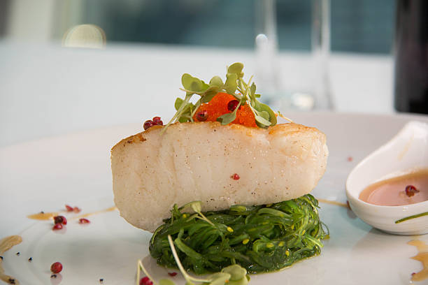 istock Gourmet Main Entree Course Grilled Snow Fish with  sauce. 531048560