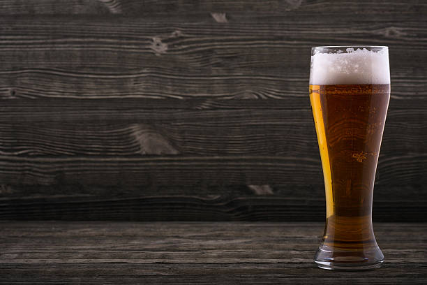 Glass of beer on a wooden countertop stock photo