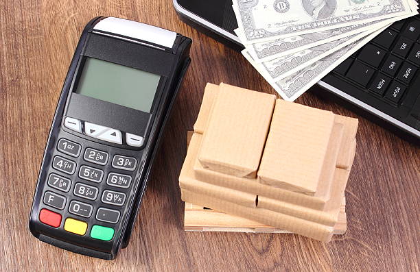 istock Payment terminal with currencies dollar, laptop and boxes on pallet 531049506