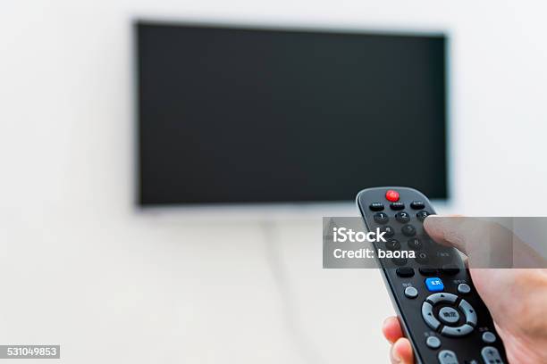 Using Tv Remote Control Stock Photo - Download Image Now - 2015, Adjusting, Adult