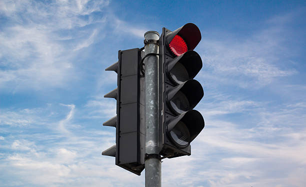 istock Red color on the traffic light on blue sky 531050580