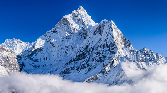 [b] 47MPix XXXXL size panorama of Mount Ama Dablam - probably the most beautiful peak in Himalayas. \n This panoramic landscape is an very high resolution multi-frame composite and is suitable for large scale printing [/b]\nAma Dablam is a mountain in the Himalaya range of eastern Nepal. The main peak is 6,812  metres, the lower western peak is 5,563 metres. Ama Dablam means  \
