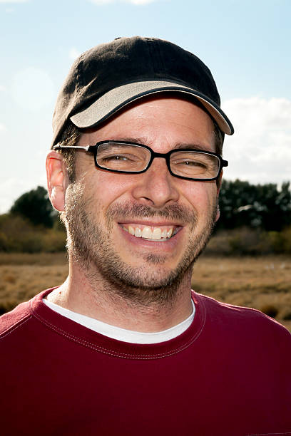istock Guy With Stubble, Baseball Cap, And Reading Glasses 531056502