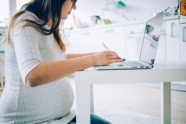 istock Pregnant woman working at home 531057512