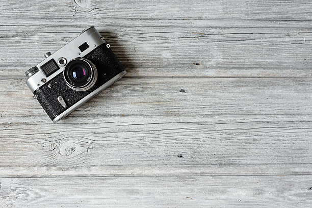 istock Vintage photo camera on the wooden table 531058812