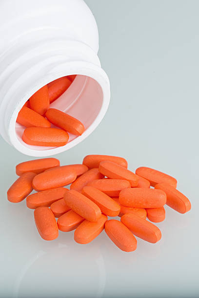 istock Orange pills with white pill bottle 531061239