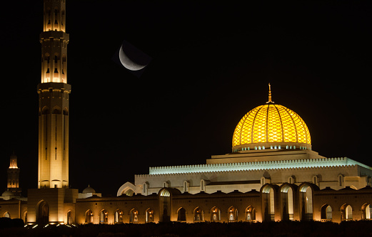 Night view of the Sultan Qaboos Grand Mosque in Muscat, Oman.  The mosque is built primarily from Indian sandstone and features one of the world's largest hand-woven carpets.  The building took over six years to build and at night is visible for several kilometers in Oman's capital city.