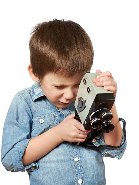 istock Little boy cameraman filming with retro camera 531061627