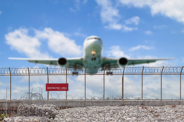 istock Restricted area fence  and Passenger airplane landing. 531062130
