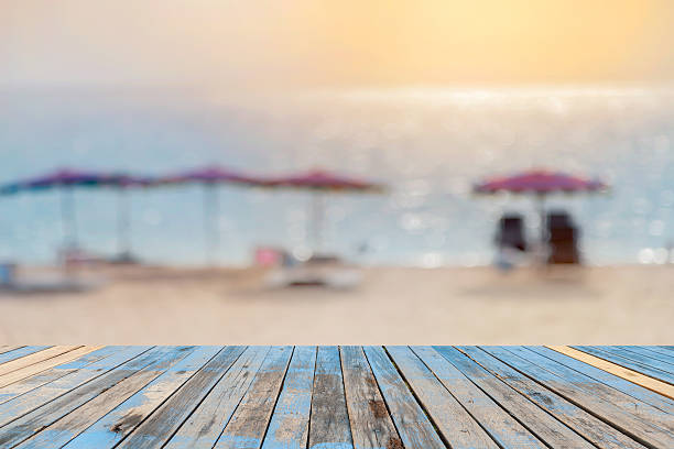 istock Wood floor on blurred sand beach background. 531062500