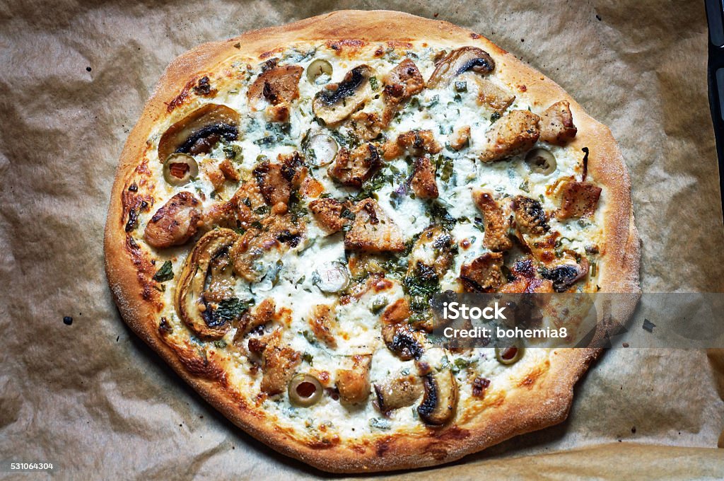 White Pizza Pizza with chicken,  mushrooms, olives, red onion and parsley on white creamy sauce Pizza Stock Photo