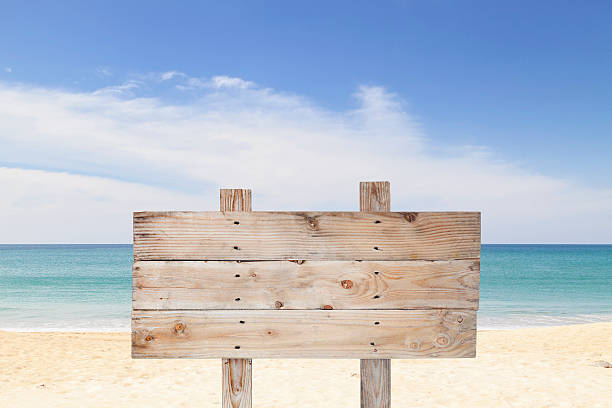 istock wooden signboard on blue sky and on tropical beach 531064394