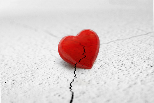 Red heart on cracked surface