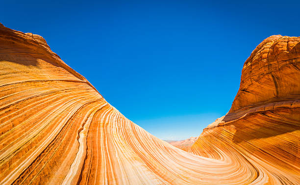 Strata swirling through desert canyon The Wave iconic landscape Arizona The vibrant swirling strata and iconic curving canyons of The Wave, the landmark rock formation deep in the Paria Canyon-Vermillion Cliffs Wilderness National Monument of Arizona and Utah, Southwest USA. ProPhoto RGB profile for maximum color fidelity and gamut. coyote buttes stock pictures, royalty-free photos & images