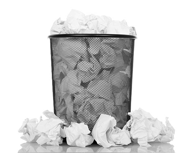 istock Black office bucket full of paper isolated on white 531069362