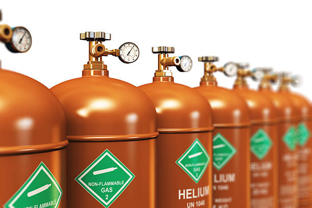 Row of liquefied helium industrial gas containers stock photo