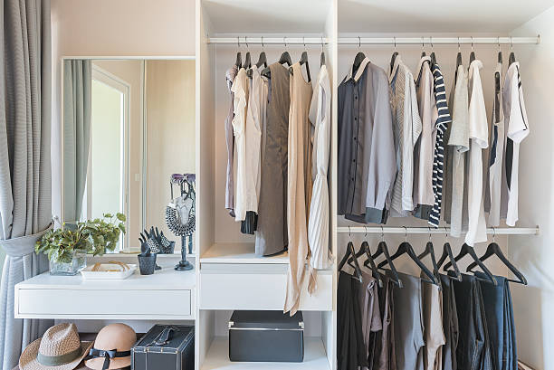 istock white wardrobe with shirts and pants hanging 531071598