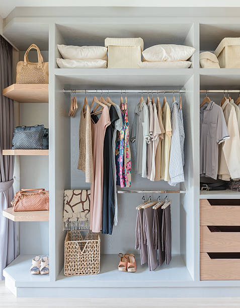 istock white wardrobe with shirts and pants hanging 531071682