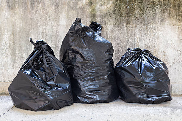 close-up of a full garbage bags on floor stock photo