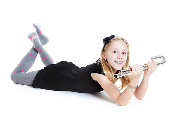 istock young blond girl holds flute lying down in studio 531075261