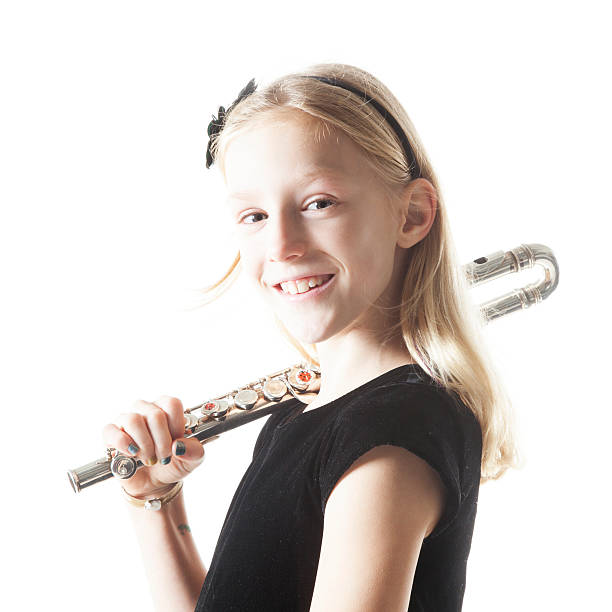 istock young blond girl holds flute in studio 531075271