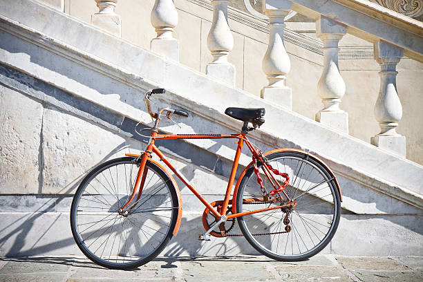 istock Orange old bicycle against a marble wall 531076759