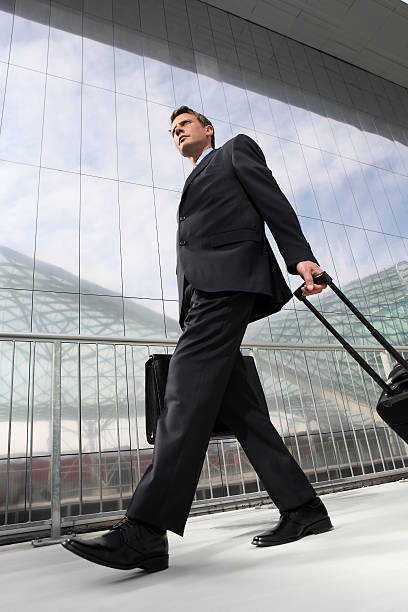 istock businessman walking with bag and trolley 531084397