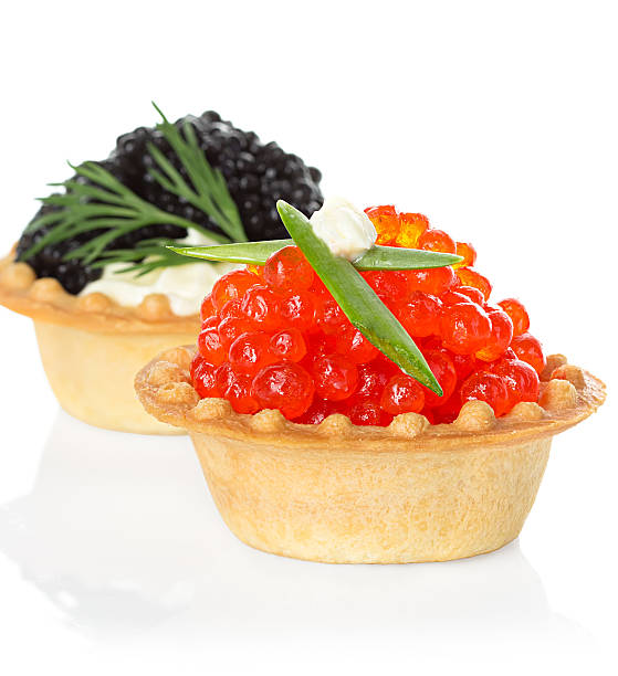 istock Tartlets with red and black caviar isolated on white background 531085001