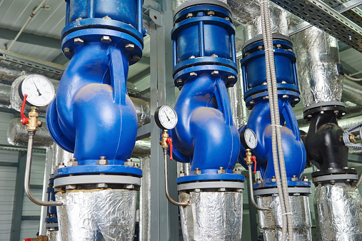 Closeup of manometer, pipes and faucet valves of gas heating system in a boiler room