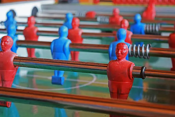 Detail of footballers  blue and red of a vintage game (table football)