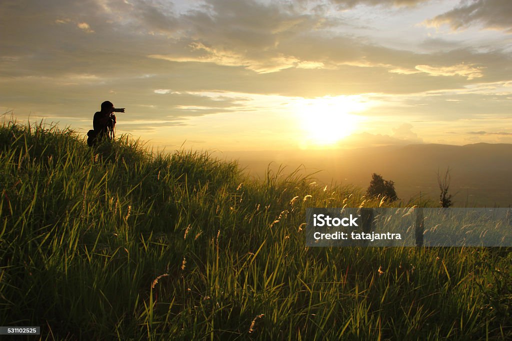 young photographer Silhouette of a young photographer during the sunset. 2015 Stock Photo