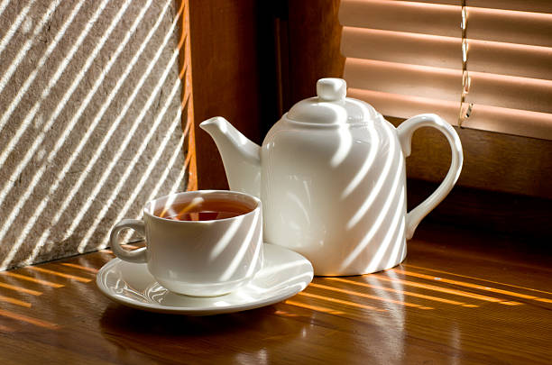 istock tea cup with teapot against the background of blinds 531102643