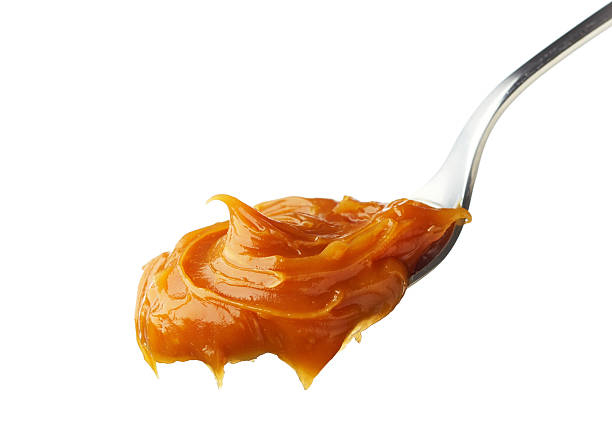istock Spoon of melted caramel cream 531106531