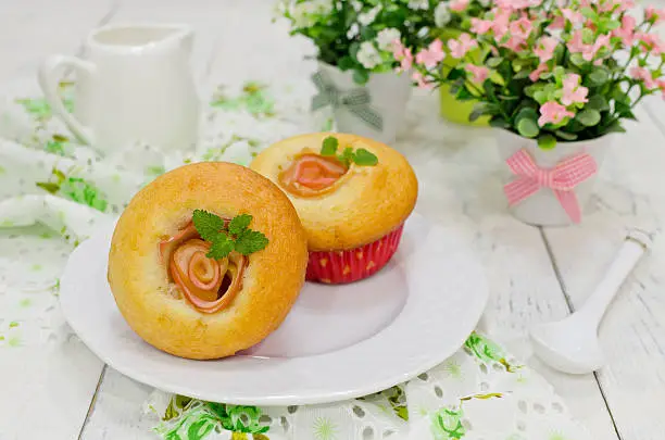 Apple muffins with fresh apples on a wooden background