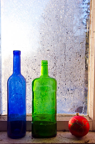 istock new year christmas toy and two old bottle on  window 531112463
