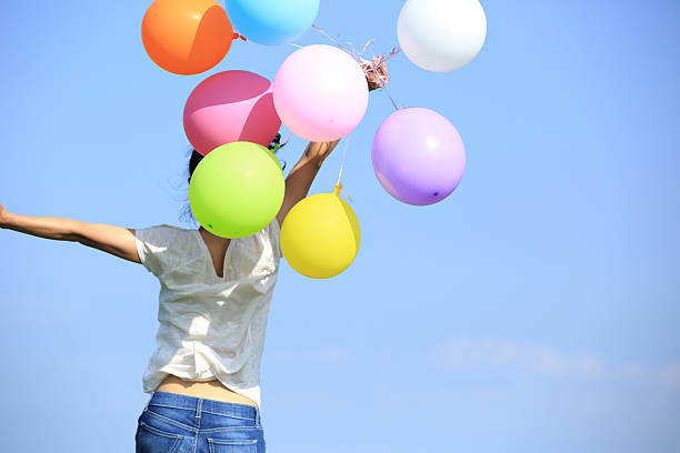 istock young asian woman  with colored balloons 531112699