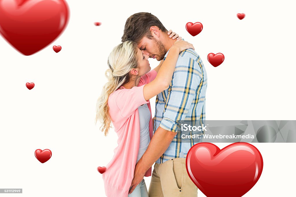 Composite image of attractive young couple about to kiss Attractive young couple about to kiss against hearts 18-19 Years Stock Photo