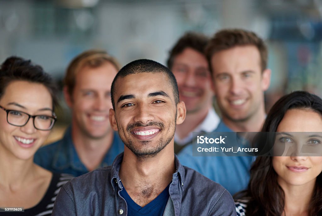 Feeling proud of our achievments Proud ethnic man smiling with his group of colleagueshttp://195.154.178.81/DATA/shoots/ic_784726.jpg Adult Stock Photo