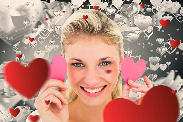 istock Composite image of attractive young blonde holding little hearts 531116969