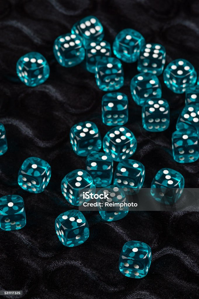 Blue dices Lots of blue transparent plastic dices on black fabric. 2015 Stock Photo
