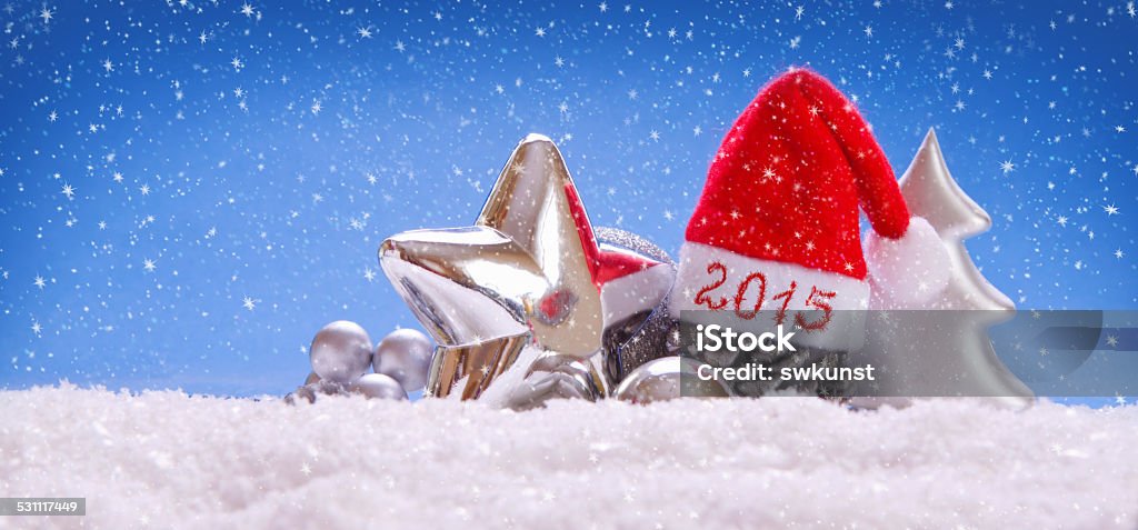 New Year 2015 and Santa hats. New Year 2015 and  Santa hats.Silver Christmas decoration. Blue Background Stock Photo