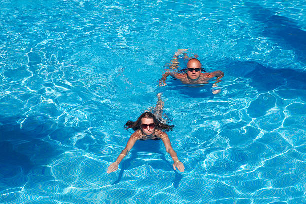 istock Couple swimming in pool 531119535