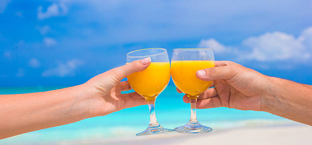 istock Closeup of two glasses on tropical white beach 531135255