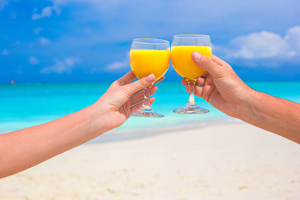 istock Closeup of two glasses on tropical white beach 531135259