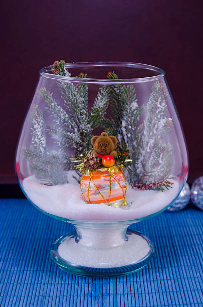 istock Toy bear in a glass vase covered with snow 531136305
