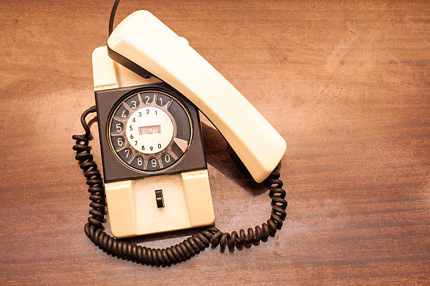 istock Vintage rotary dial telephone on old wooden table. 531138705
