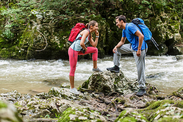 istock Young couple hiking by the river 531138863
