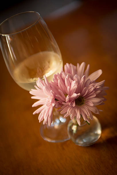 istock Wine glass by pink flowers 531138987