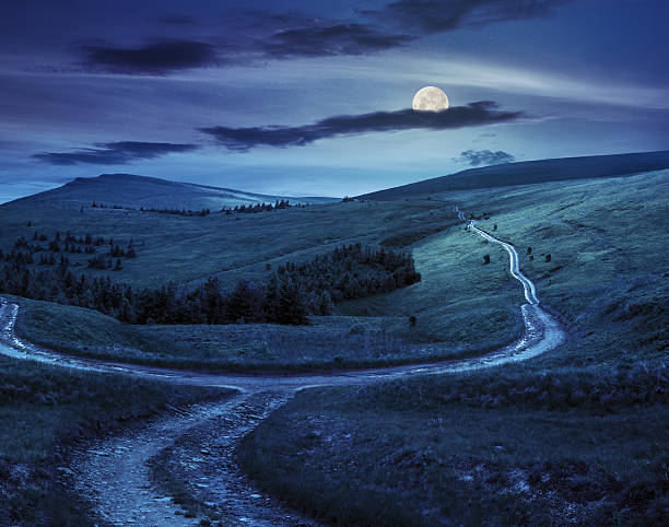 istock cross road on hillside meadow in mountain  at night 531140131