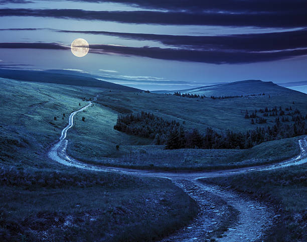istock cross road on hillside meadow in mountain  at night 531141061
